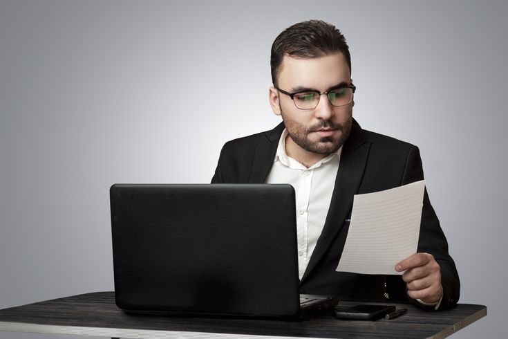 admin_eibil/products_images/Image of an employee sitting at his desk and reading the paper.jpeg